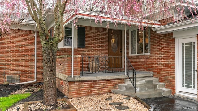 property entrance with brick siding