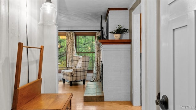 entryway with crown molding and wood finished floors