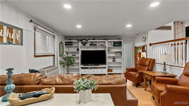 living area with light wood-type flooring, recessed lighting, and cooling unit