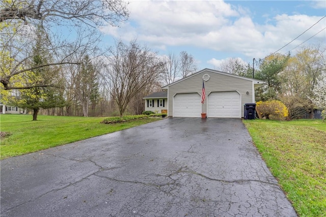 view of front facade featuring an attached garage, a front yard, and aphalt driveway