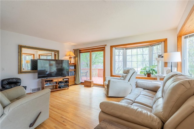 living area featuring visible vents and light wood-style flooring