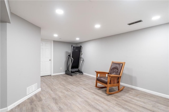 living area featuring recessed lighting, visible vents, and light wood-type flooring