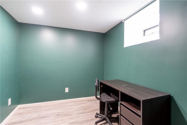 home office featuring baseboards and wood finished floors