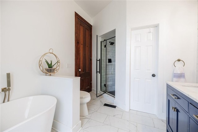 bathroom featuring vanity, toilet, marble finish floor, a freestanding tub, and a shower stall