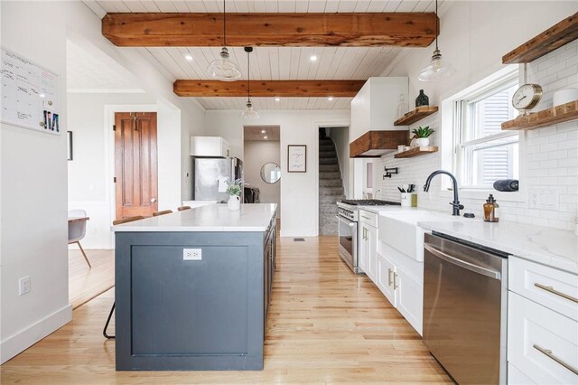 kitchen featuring white cabinets, open shelves, beam ceiling, light wood-style flooring, and stainless steel appliances
