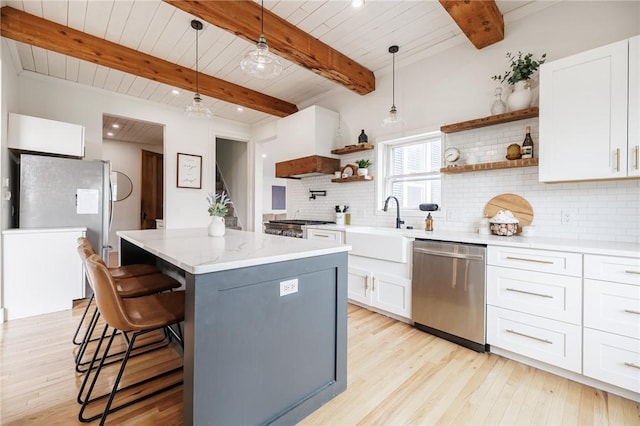kitchen featuring light wood-style floors, open shelves, dishwasher, and a kitchen island