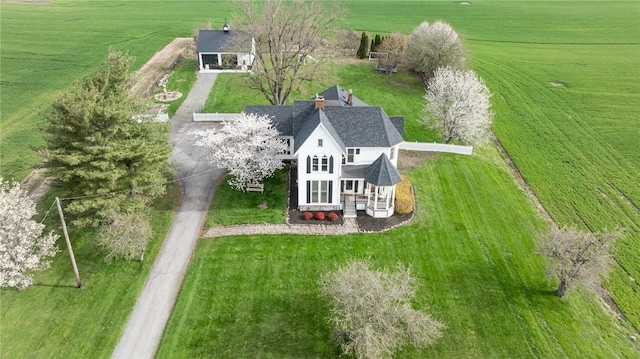 birds eye view of property with a rural view