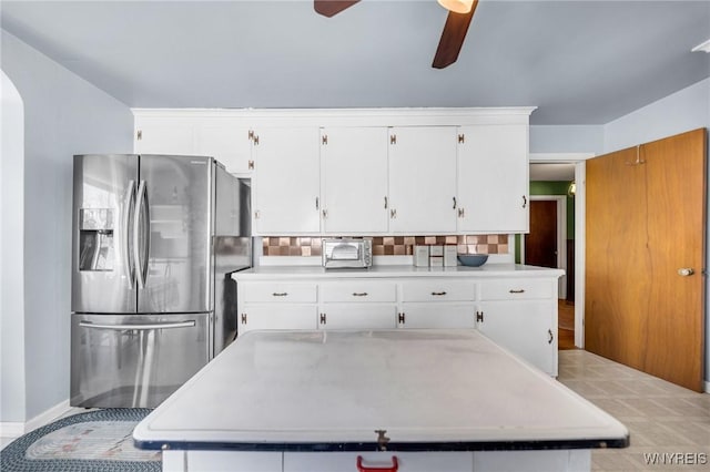 kitchen featuring light countertops, ceiling fan, white cabinets, and stainless steel fridge with ice dispenser