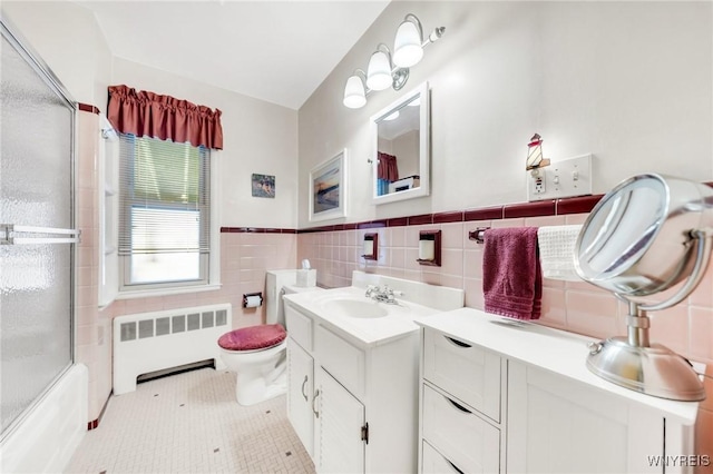 full bathroom with wainscoting, vanity, toilet, radiator, and tile walls