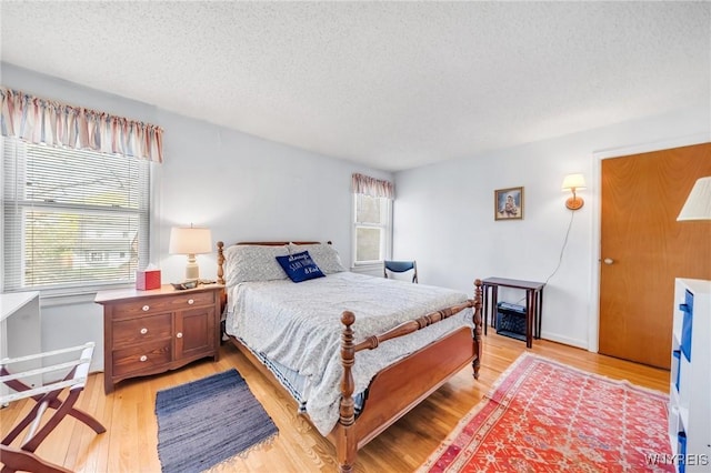 bedroom featuring a textured ceiling and light wood-type flooring