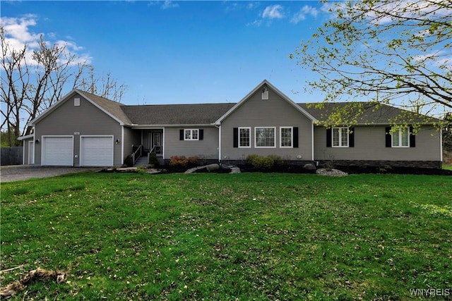 ranch-style home featuring a garage, driveway, and a front yard