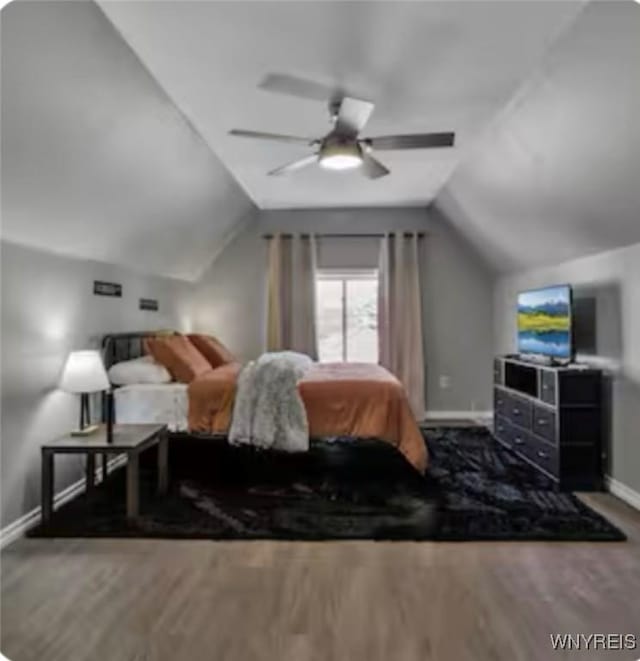 bedroom with baseboards, a ceiling fan, wood finished floors, and vaulted ceiling