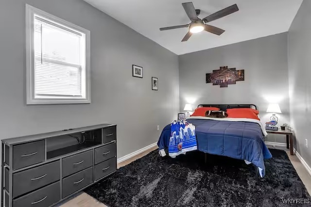 bedroom featuring baseboards and a ceiling fan