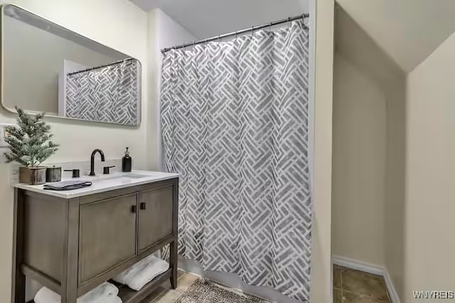 full bathroom featuring vanity, tile patterned flooring, and curtained shower