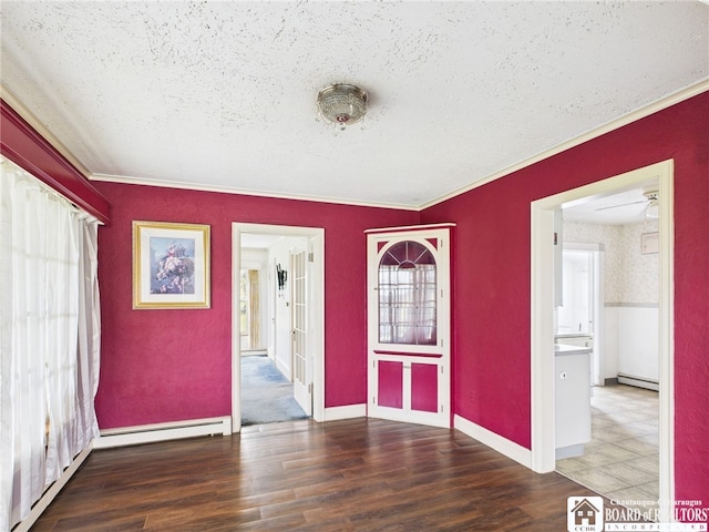 interior space with crown molding, a textured ceiling, a baseboard heating unit, and wood finished floors