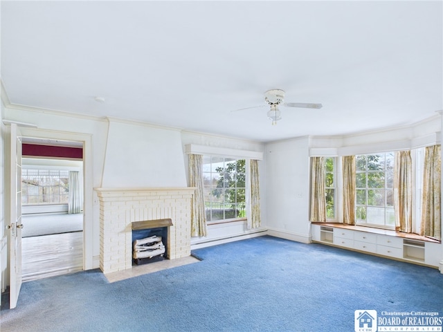 unfurnished living room featuring carpet floors, ceiling fan, ornamental molding, and a brick fireplace