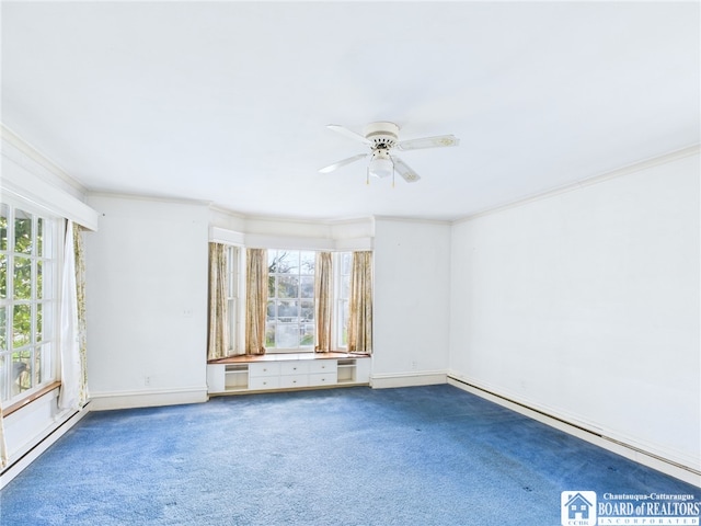 empty room featuring a healthy amount of sunlight, ceiling fan, carpet, and crown molding