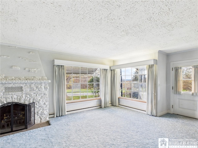 unfurnished living room featuring plenty of natural light, carpet, and a textured ceiling