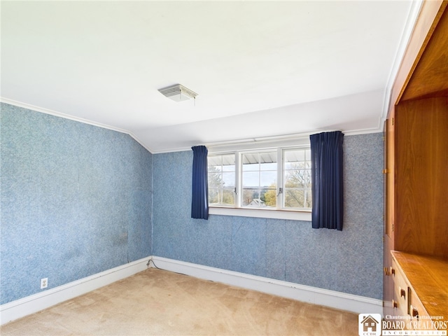 unfurnished room with crown molding, baseboards, wallpapered walls, and carpet