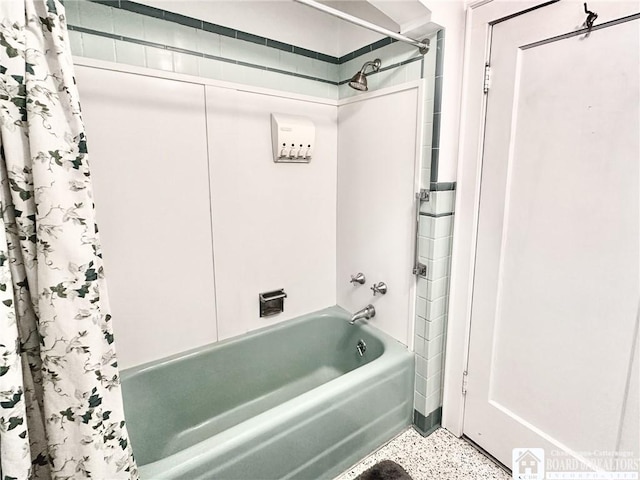bathroom with speckled floor and shower / tub combo with curtain