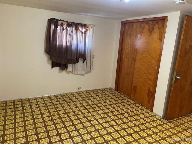 unfurnished bedroom featuring tile patterned floors and a closet