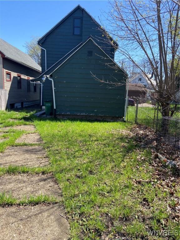 view of side of property featuring fence