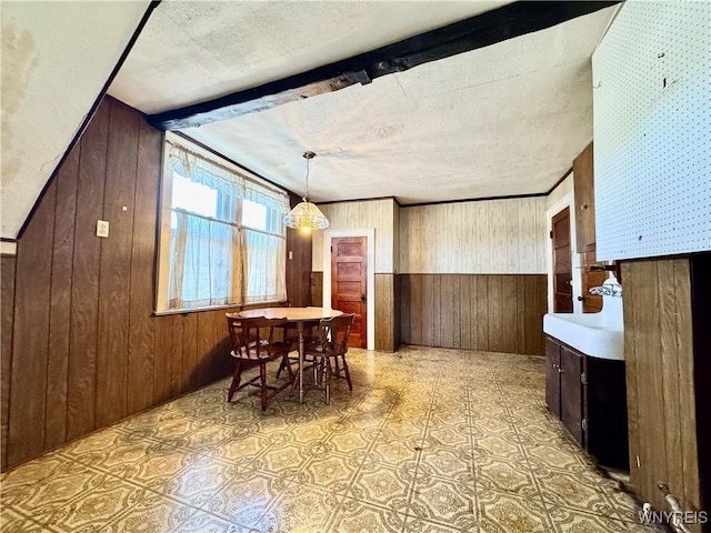 dining room featuring wooden walls and light floors