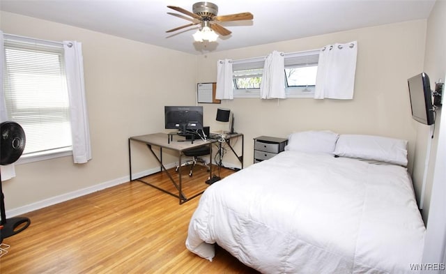 bedroom with baseboards, a ceiling fan, and wood finished floors