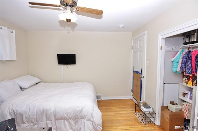 bedroom with baseboards, a ceiling fan, and wood finished floors