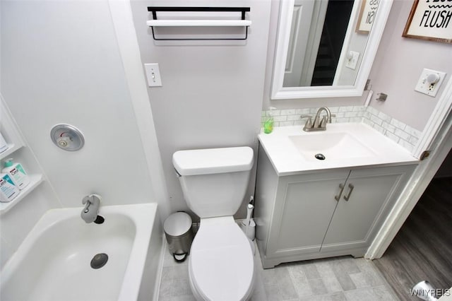 full bath featuring toilet, a bathtub, and vanity