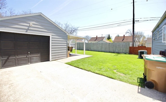 view of yard featuring fence, central AC, a garage, concrete driveway, and an outdoor structure