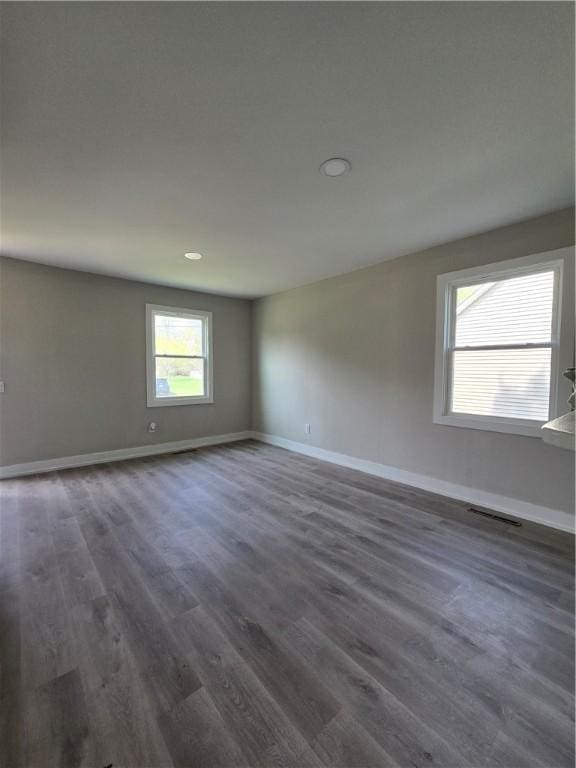 506 Luce St, Elmira-City, NY 14904 - spare room featuring baseboards, dark wood-type flooring, and recessed lighting