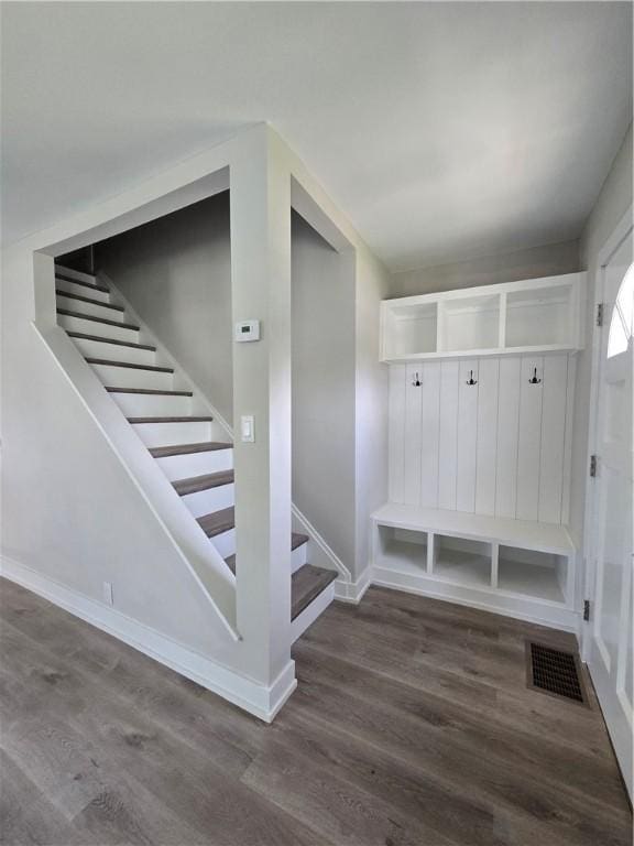 mudroom with baseboards, wood finished floors, and visible vents