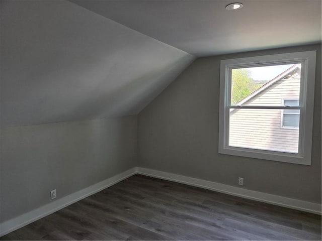 bonus room with dark wood-style flooring, baseboards, vaulted ceiling, and recessed lighting