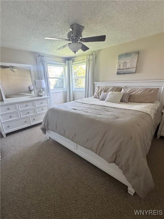 bedroom featuring carpet flooring, a textured ceiling, and ceiling fan