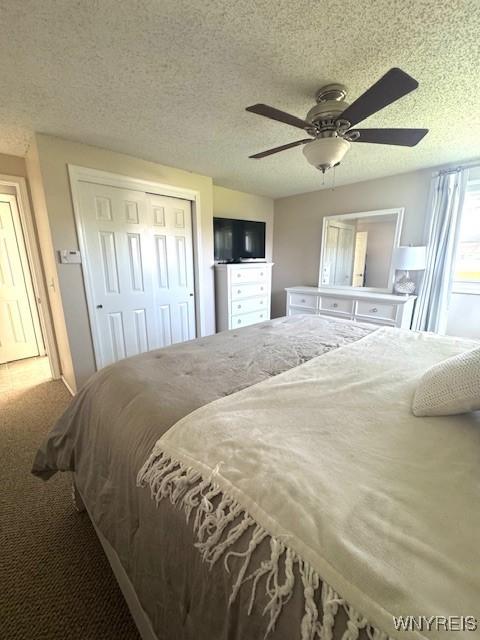 carpeted bedroom featuring a closet, a textured ceiling, and ceiling fan