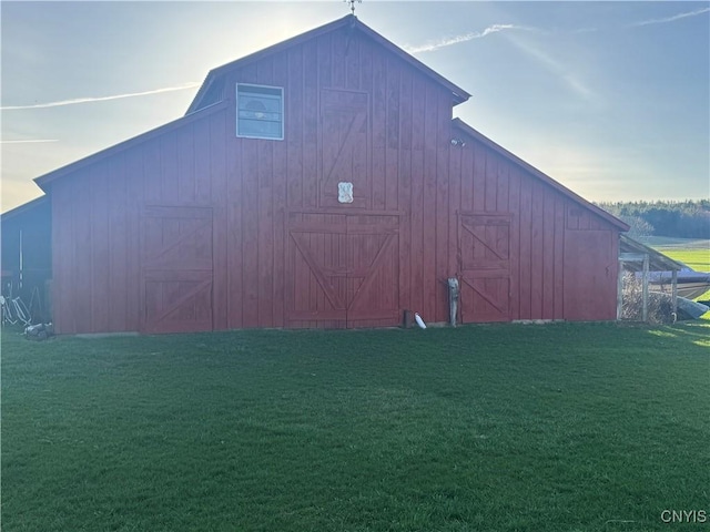 view of barn with a lawn