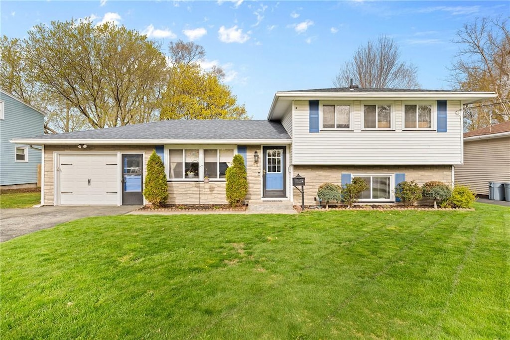 49 Chad Cir, Greece, NY 14616 - tri-level home featuring a garage, a front yard, and aphalt driveway