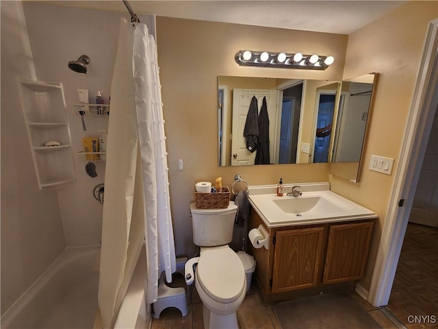 bathroom with vanity, shower / bath combo with shower curtain, and toilet