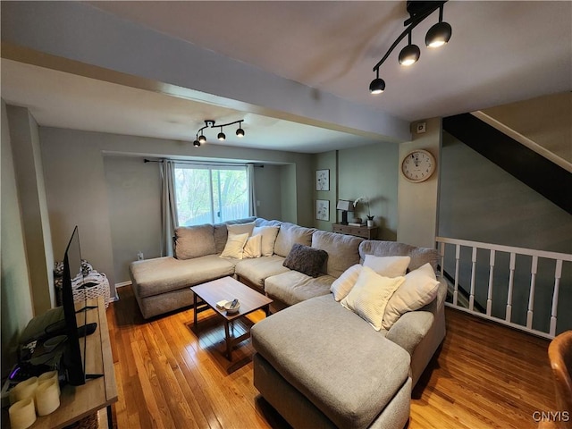 living room featuring beamed ceiling and wood-type flooring
