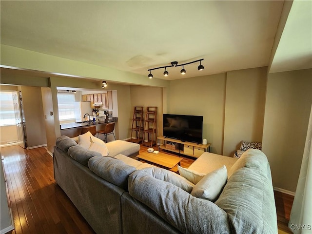 living area with baseboards and hardwood / wood-style flooring