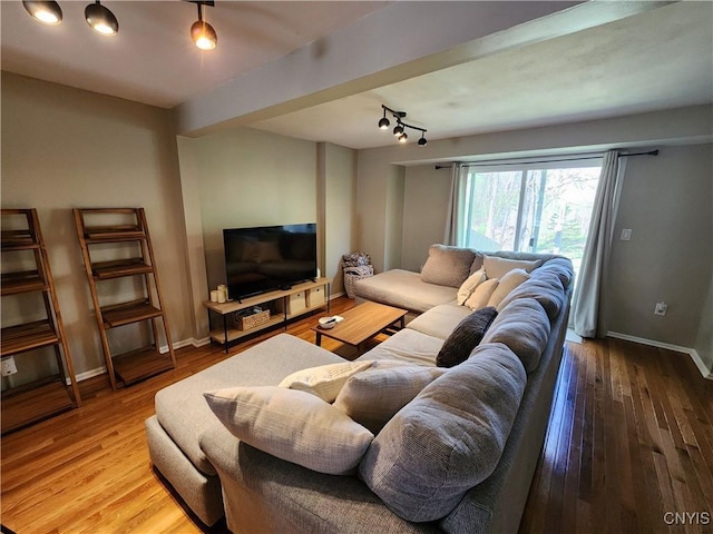 living room with baseboards and wood finished floors