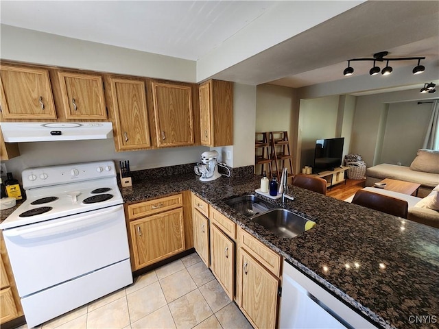 kitchen featuring light tile patterned flooring, white appliances, open floor plan, under cabinet range hood, and a sink