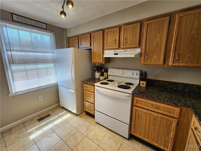 kitchen featuring brown cabinets, white appliances, light tile patterned floors, under cabinet range hood, and visible vents