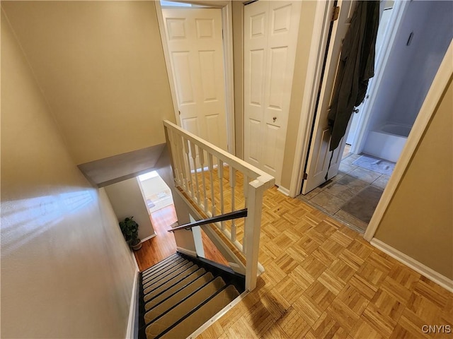 staircase featuring baseboards