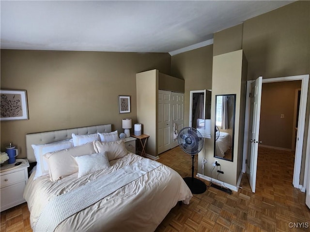 bedroom with baseboards and vaulted ceiling