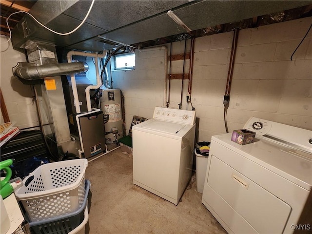 laundry area featuring laundry area, heating unit, independent washer and dryer, and gas water heater
