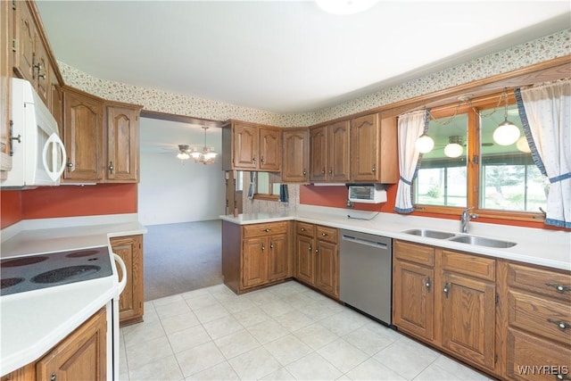 kitchen with brown cabinets, a sink, light countertops, light carpet, and white appliances