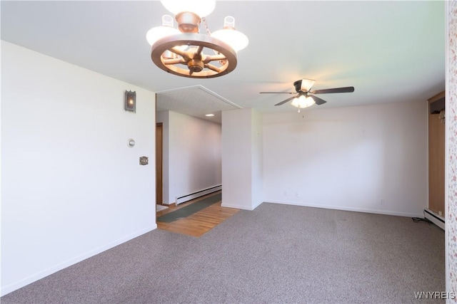 carpeted empty room with attic access, ceiling fan with notable chandelier, baseboards, a baseboard radiator, and a baseboard heating unit
