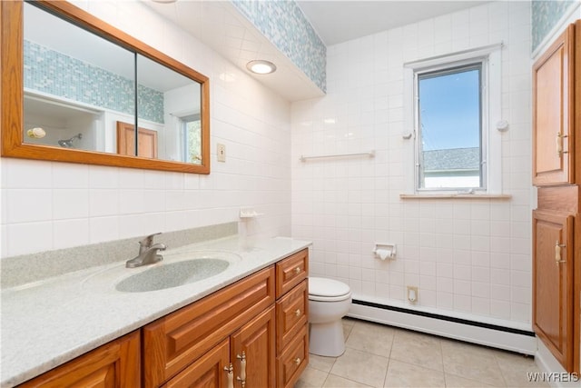 bathroom with vanity, tile walls, a baseboard heating unit, and toilet